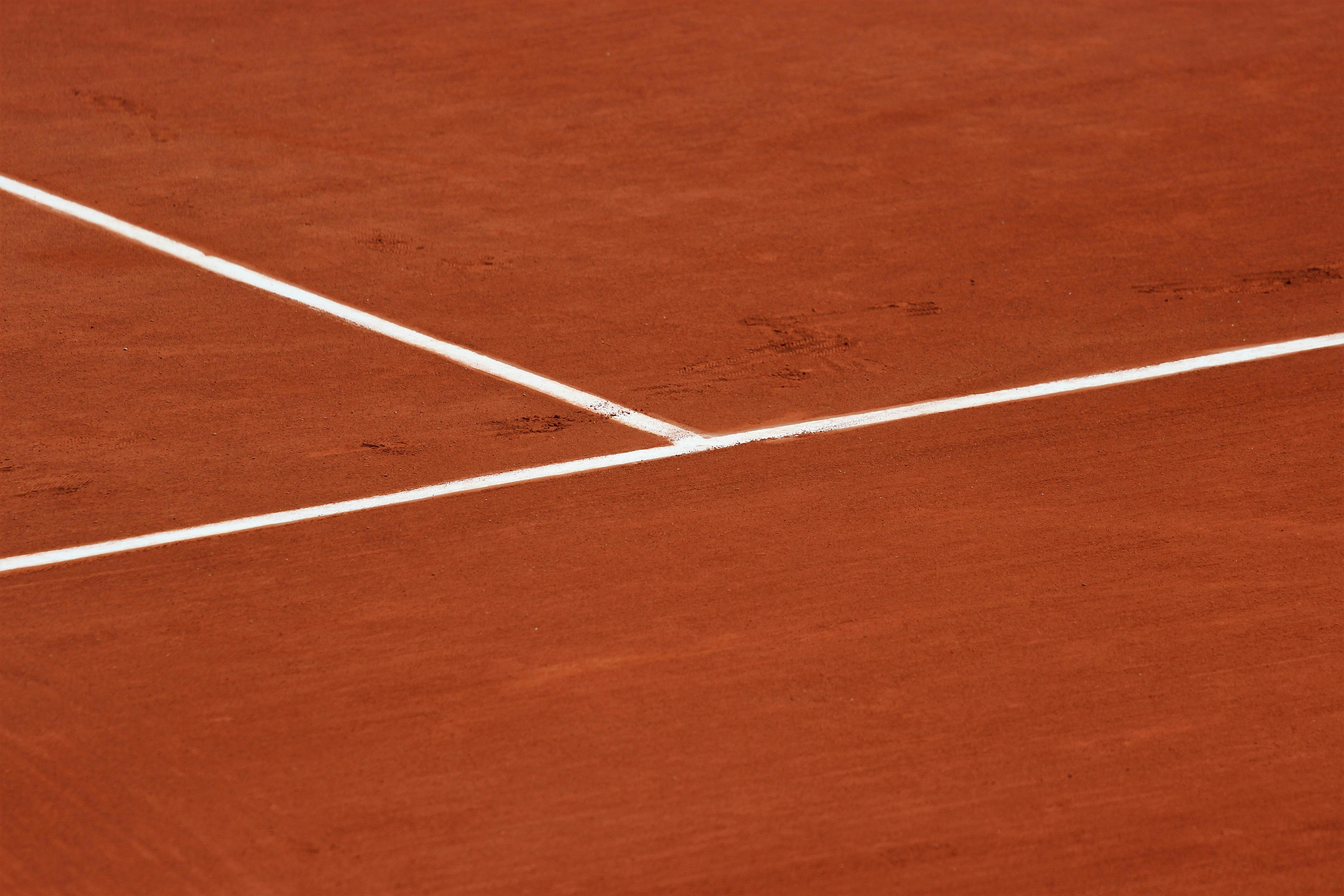 Clay tennis court with white lines